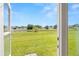 Beautiful backyard view of a pond and lawn through a door at 11422 Captiva Kay Dr, Riverview, FL 33569