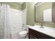 Bathroom with neutral green walls, shower with curtain, toilet, and vanity with dark cabinets at 11422 Captiva Kay Dr, Riverview, FL 33569