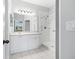 Bathroom features a sink, white cabinetry, and walk-in shower with grab bars at 11422 Captiva Kay Dr, Riverview, FL 33569