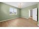 Bedroom with multiple windows, neutral paint, and wood-look floors at 11422 Captiva Kay Dr, Riverview, FL 33569