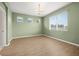 Bedroom with multiple windows, neutral paint, and wood-look floors at 11422 Captiva Kay Dr, Riverview, FL 33569