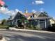 View of the Rivercrest clubhouse entrance with an American flag, landscaping, and street at 11422 Captiva Kay Dr, Riverview, FL 33569