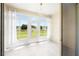 Bright Florida room with tile flooring, and large windows offering beautiful backyard views at 11422 Captiva Kay Dr, Riverview, FL 33569