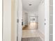 Bright foyer with tiled flooring transitions to wood, leading into a living space with sliding glass doors at 11422 Captiva Kay Dr, Riverview, FL 33569