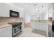 Modern kitchen with stainless steel appliances, white cabinets, and a stylish backsplash at 11422 Captiva Kay Dr, Riverview, FL 33569