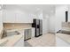 Spacious kitchen features stainless steel appliances, white cabinetry, and tile flooring at 11422 Captiva Kay Dr, Riverview, FL 33569