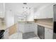 Well-lit kitchen featuring stainless steel appliances, white cabinetry, and views into the living room at 11422 Captiva Kay Dr, Riverview, FL 33569