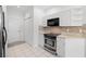 Well-equipped kitchen features stainless steel appliances and ample white cabinetry at 11422 Captiva Kay Dr, Riverview, FL 33569