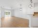 Spacious living room boasts wood floors, modern light fixtures, and sliding glass doors to the outside at 11422 Captiva Kay Dr, Riverview, FL 33569