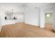 Open-concept living area features wood-look floors and view of modern pendant lighting at 11422 Captiva Kay Dr, Riverview, FL 33569