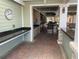Outdoor kitchen area with granite countertops, stainless steel appliances, and brick flooring at 11422 Captiva Kay Dr, Riverview, FL 33569