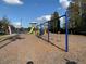 Community playground featuring swings, slides, and play structures, set against a backdrop of mature trees at 11422 Captiva Kay Dr, Riverview, FL 33569