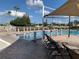 View of the pool's zero entry, featuring lounge chairs and a shaded area at 11422 Captiva Kay Dr, Riverview, FL 33569