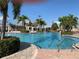 Large swimming pool with palm trees, pergolas, lounge chairs, and clear blue skies at 11422 Captiva Kay Dr, Riverview, FL 33569