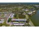 Aerial view of the community featuring pond, lush landscaping, and condo buildings at 117 Martha Ln # 117, Oldsmar, FL 34677