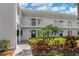 Condo exterior showcasing well maintained landscaping, clean white siding, and second story balcony at 117 Martha Ln # 117, Oldsmar, FL 34677