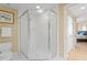 Corner shower in a well-lit bathroom, next to a bedroom entrance and white toilet at 1180 Gulf Blvd # 1604, Clearwater Beach, FL 33767