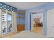 Blue bedroom featuring interior entryways, shelves, and a balcony with an ocean view at 1180 Gulf Blvd # 1604, Clearwater Beach, FL 33767