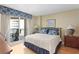 Cozy bedroom featuring balcony access, decorative lamps, and a comfortable bed with patterned pillows at 1180 Gulf Blvd # 1604, Clearwater Beach, FL 33767