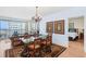 Bright dining room featuring chandelier, area rug, and balcony access with ocean view at 1180 Gulf Blvd # 1604, Clearwater Beach, FL 33767