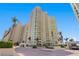 Stunning exterior shot of the high-rise condominium with meticulous landscaping and palm trees at 1180 Gulf Blvd # 1604, Clearwater Beach, FL 33767