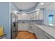 Well-lit kitchen featuring white cabinets, stainless steel refrigerator, and modern appliances at 1180 Gulf Blvd # 1604, Clearwater Beach, FL 33767