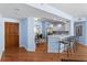 Inviting living area featuring hardwood floors and open floor plan to modern kitchen with breakfast bar at 1180 Gulf Blvd # 1604, Clearwater Beach, FL 33767