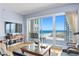 Bright living room with ocean view through sliding glass doors leading to balcony at 1180 Gulf Blvd # 1604, Clearwater Beach, FL 33767