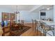 Open living area with dining table, kitchen breakfast bar, and television at 1180 Gulf Blvd # 1604, Clearwater Beach, FL 33767