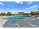 Large community pool with lounge chairs and tropical landscaping creating a relaxing and luxurious outdoor space at 1180 Gulf Blvd # 1604, Clearwater Beach, FL 33767