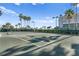 Full tennis court with palm tree accents perfect for an active lifestyle and recreational enjoyment at 1180 Gulf Blvd # 1604, Clearwater Beach, FL 33767