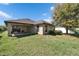 Inviting backyard with a covered patio area and seating, ideal for relaxing or entertaining guests at 12220 Legacy Bright St, Riverview, FL 33578
