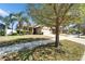 Well-maintained home with a two-car garage, stone accents, and mature trees at 12220 Legacy Bright St, Riverview, FL 33578
