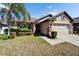 Attractive home with a two-car garage and stone accents on a well-manicured lawn at 12220 Legacy Bright St, Riverview, FL 33578