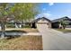 Inviting home featuring a two-car garage, stone accents, and manicured landscaping at 12220 Legacy Bright St, Riverview, FL 33578