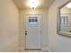 Classic white front door with glass pane and sidelight, leading into the home at 12220 Legacy Bright St, Riverview, FL 33578