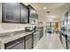 Modern kitchen featuring granite countertops, stainless steel appliances, and ample cabinet space at 12220 Legacy Bright St, Riverview, FL 33578