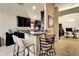 Open kitchen and bar area with granite counters and tile flooring and view of computer room at 12220 Legacy Bright St, Riverview, FL 33578