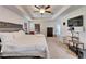 Spacious main bedroom featuring a ceiling fan, TV, and access to a back porch at 12220 Legacy Bright St, Riverview, FL 33578