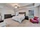 Spacious main bedroom features a tray ceiling, large window, and lots of natural light at 12220 Legacy Bright St, Riverview, FL 33578