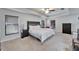 Spacious main bedroom features a tray ceiling, large window, and lots of natural light at 12220 Legacy Bright St, Riverview, FL 33578