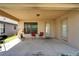 Relaxing covered patio with outdoor seating, grill, and backyard access at 12220 Legacy Bright St, Riverview, FL 33578