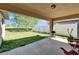 Covered patio with a grill, chairs, and a view of the expansive backyard and white fence at 12220 Legacy Bright St, Riverview, FL 33578