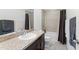 Well-lit bathroom features a vanity, toilet, and shower-tub combination at 12377 Streambed Dr, Riverview, FL 33579