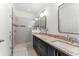 Elegant bathroom showcasing a double vanity with granite counters, framed mirrors, and a glass-enclosed shower at 12377 Streambed Dr, Riverview, FL 33579