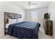 Bedroom with ceiling fan, window, and furniture for comfortable living at 12377 Streambed Dr, Riverview, FL 33579