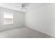 Bedroom with neutral carpet, white walls, ceiling fan, and bright window at 12377 Streambed Dr, Riverview, FL 33579