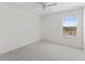 Bedroom with neutral carpet, white walls, and a window with a view at 12377 Streambed Dr, Riverview, FL 33579