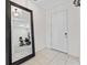 Inviting entryway featuring neutral tile floors and a large mirror with a view of the office space at 12377 Streambed Dr, Riverview, FL 33579