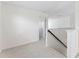 Bright upstairs hallway features carpet, white walls, and white trim at 12377 Streambed Dr, Riverview, FL 33579